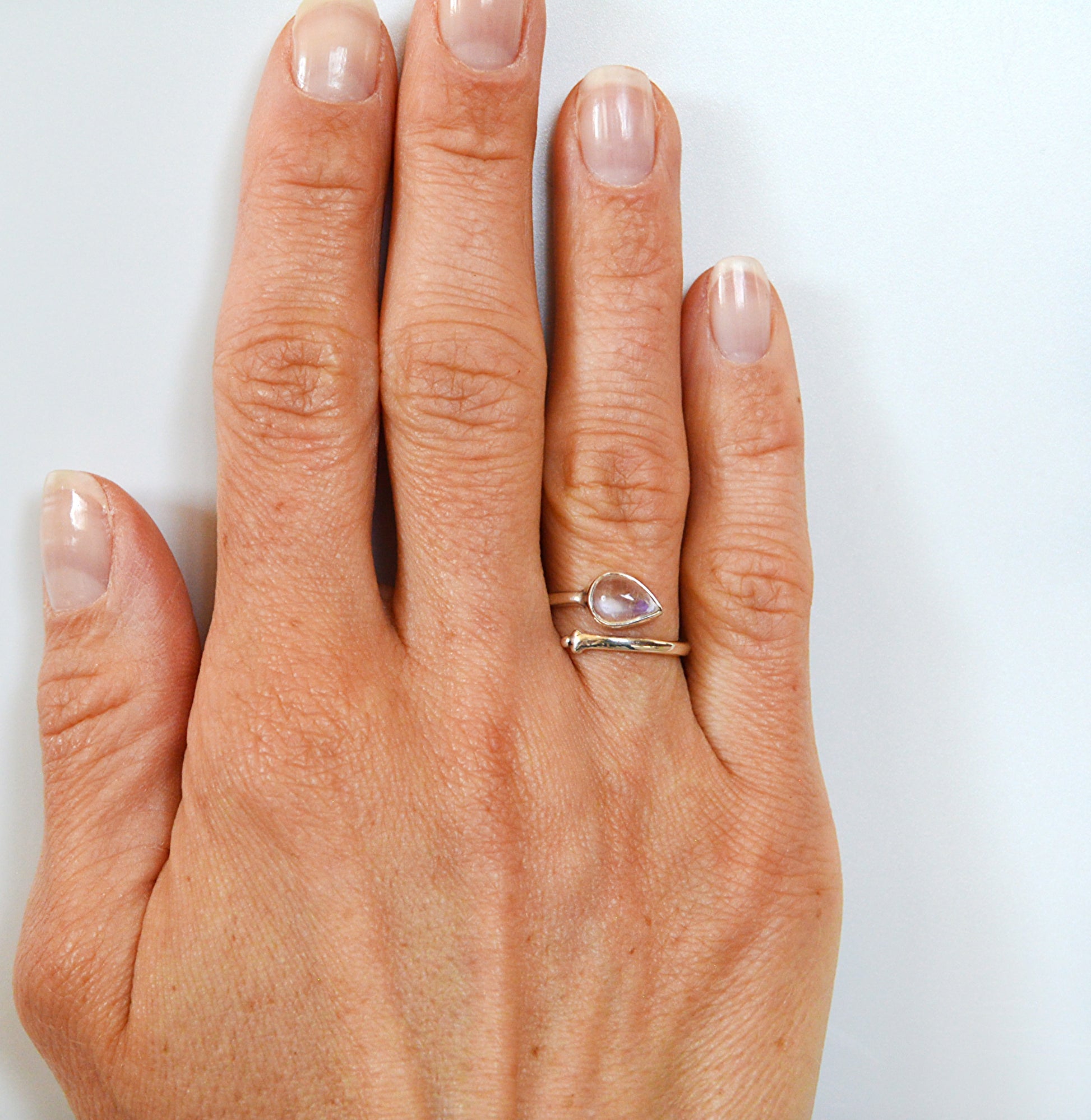 sterling silver ring using an adjustable band and a moonstone center stone.