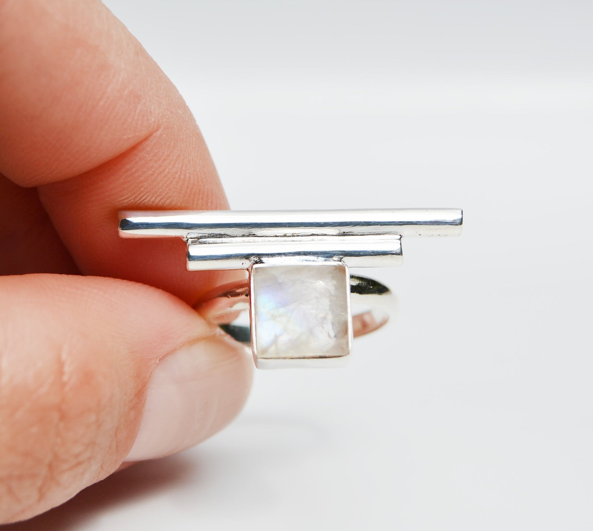 JeniMarie Jewelry with a statement ring using a square white and milky moonstone with accent bars all set in sterling silver. 