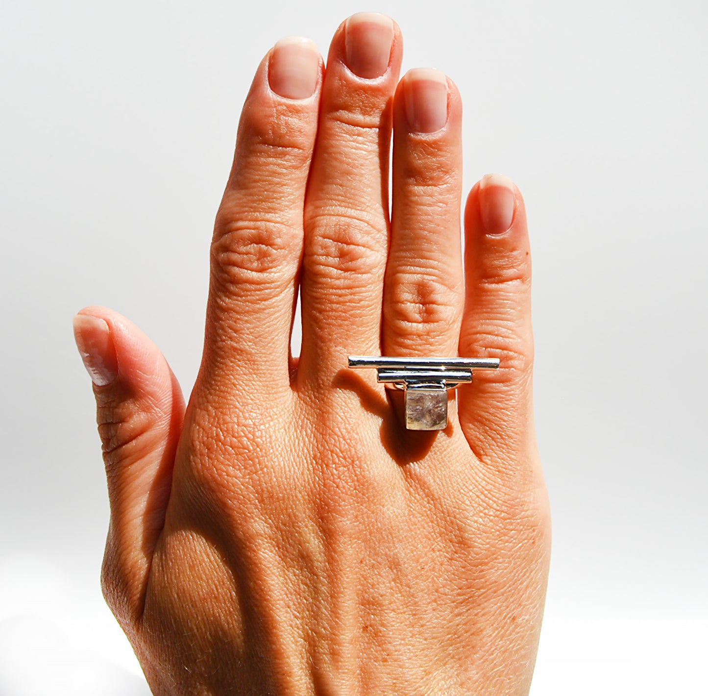 JeniMarie Jewelry with a beautiful and fun white moonstone square stone ring with accent bars set in sterling silver for a high polish and shine. 