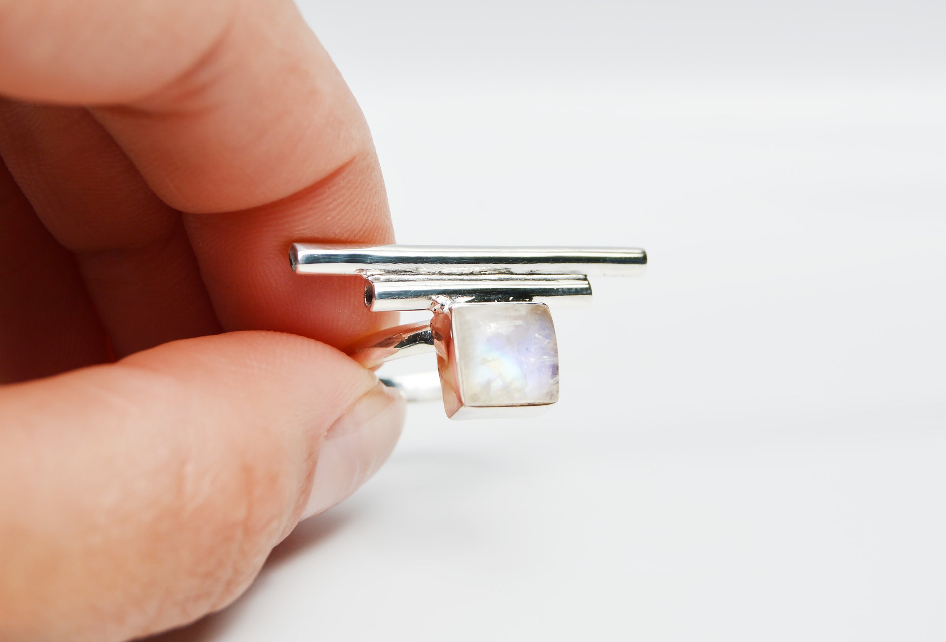 JeniMarie Jewelry with rare and unique ring with a square moonstone stone set in sterling silver with sterling silver accent bars. 