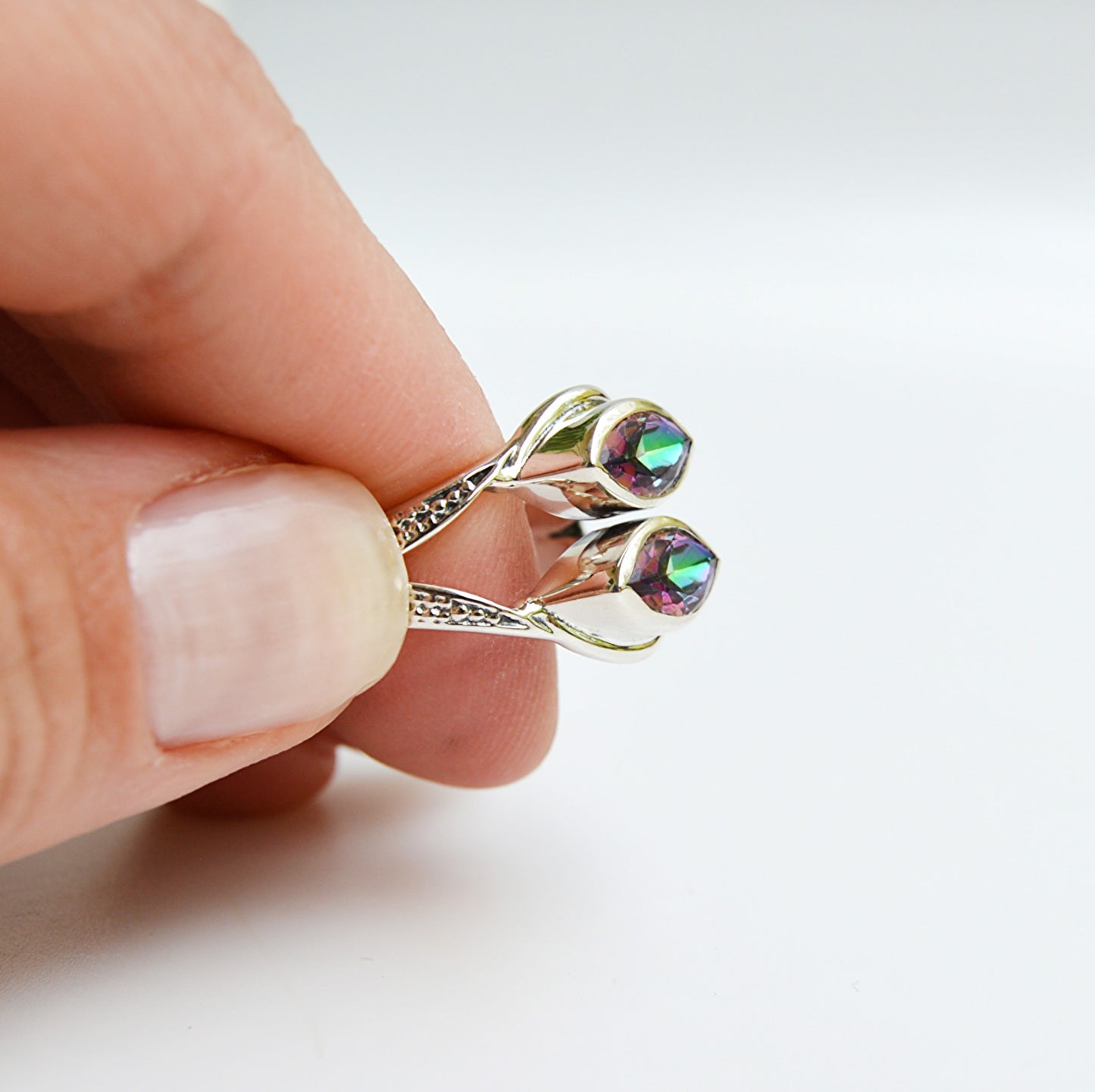 JeniMarie Jewelry with a double stone mystic topaz and designed band all set in .925 sterling silver making the piece hypoallergenic. 