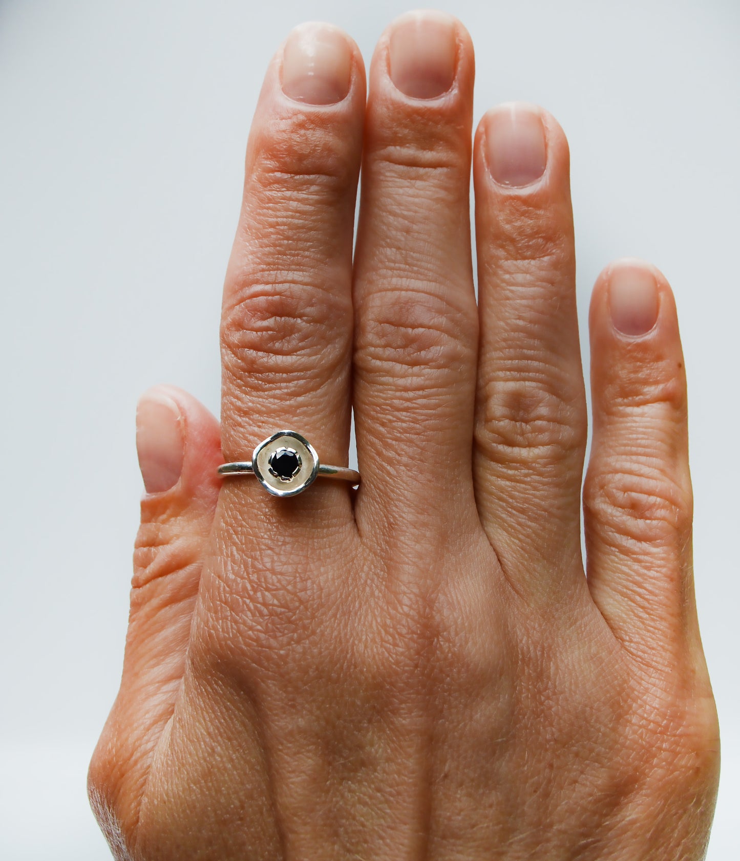 JeniMarie Jewelry with a beautiful black onyx ring set in a flower design all using sterling silver and hand polished for a high shine. 