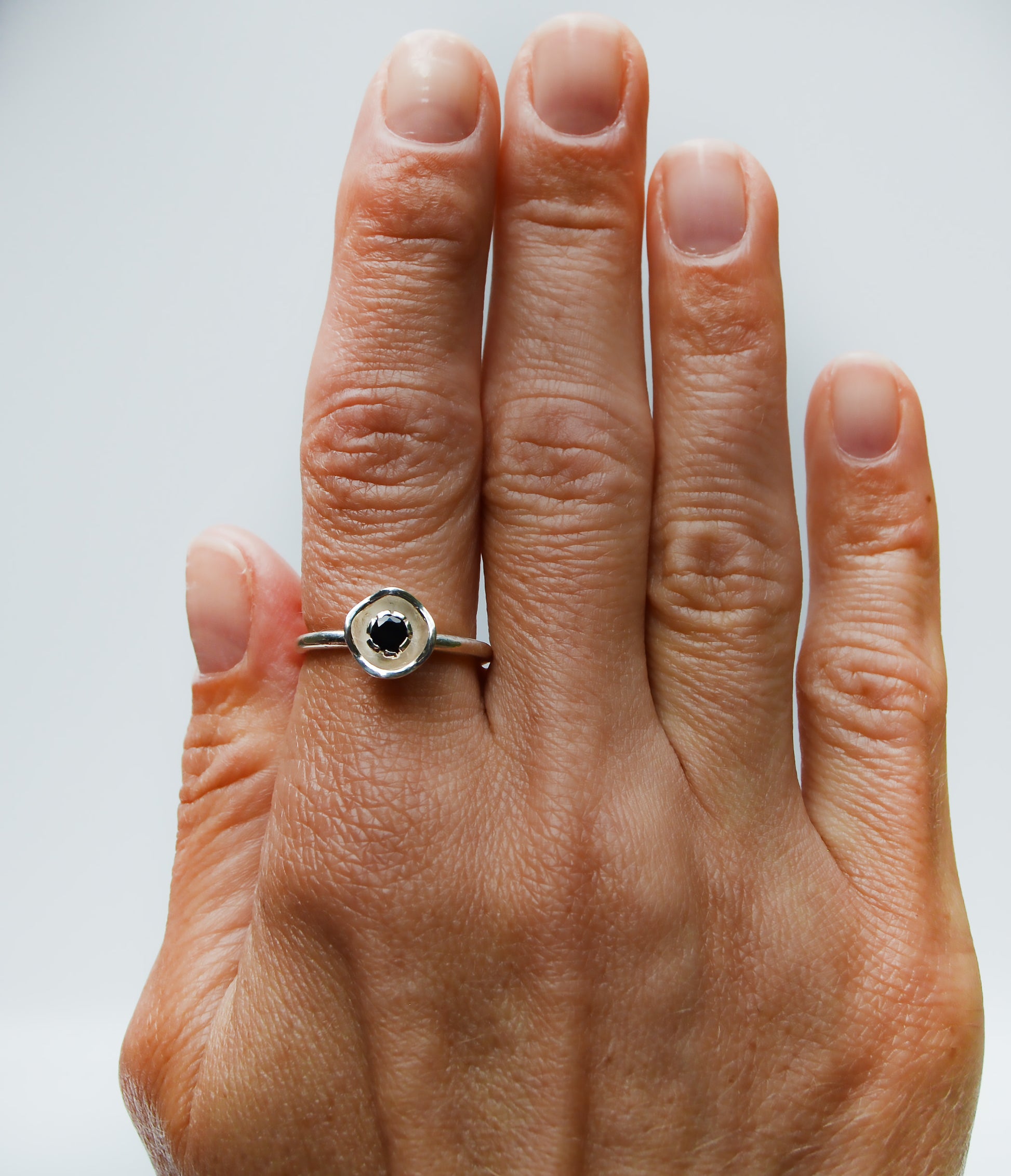 JeniMarie Jewelry with a beautiful black onyx ring set in a flower design all using sterling silver and hand polished for a high shine. 
