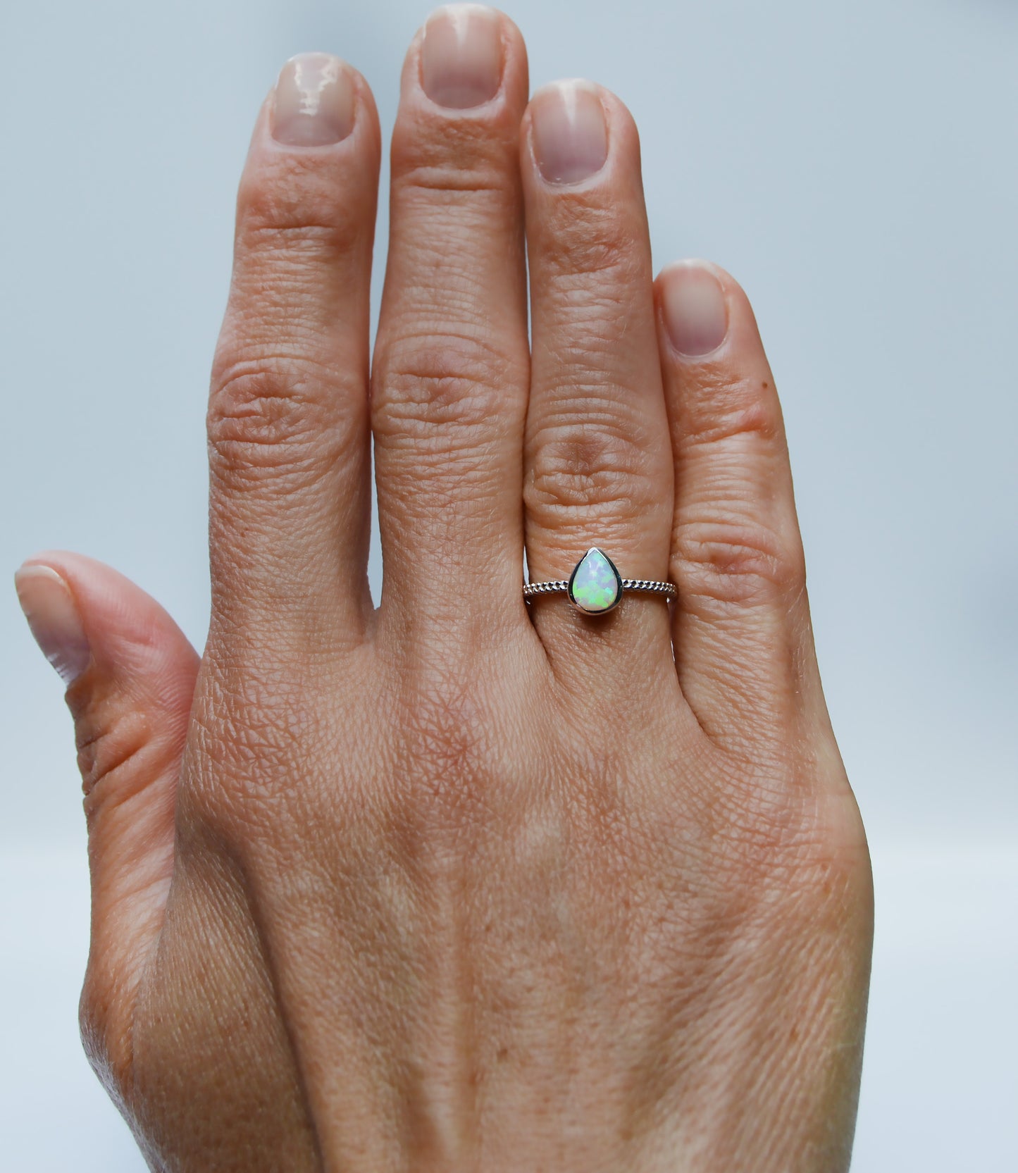 JeniMarie Jewelry with a beautiful opal ring set in sterling silver and a textured band for added design. 