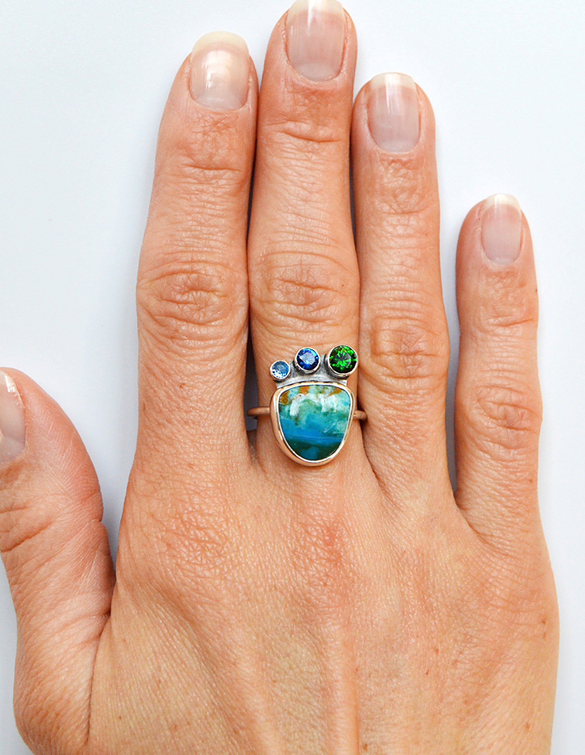 Rare Peruvian Opal ring with accent tube set stones including London Blue Topaz and Emerald. 