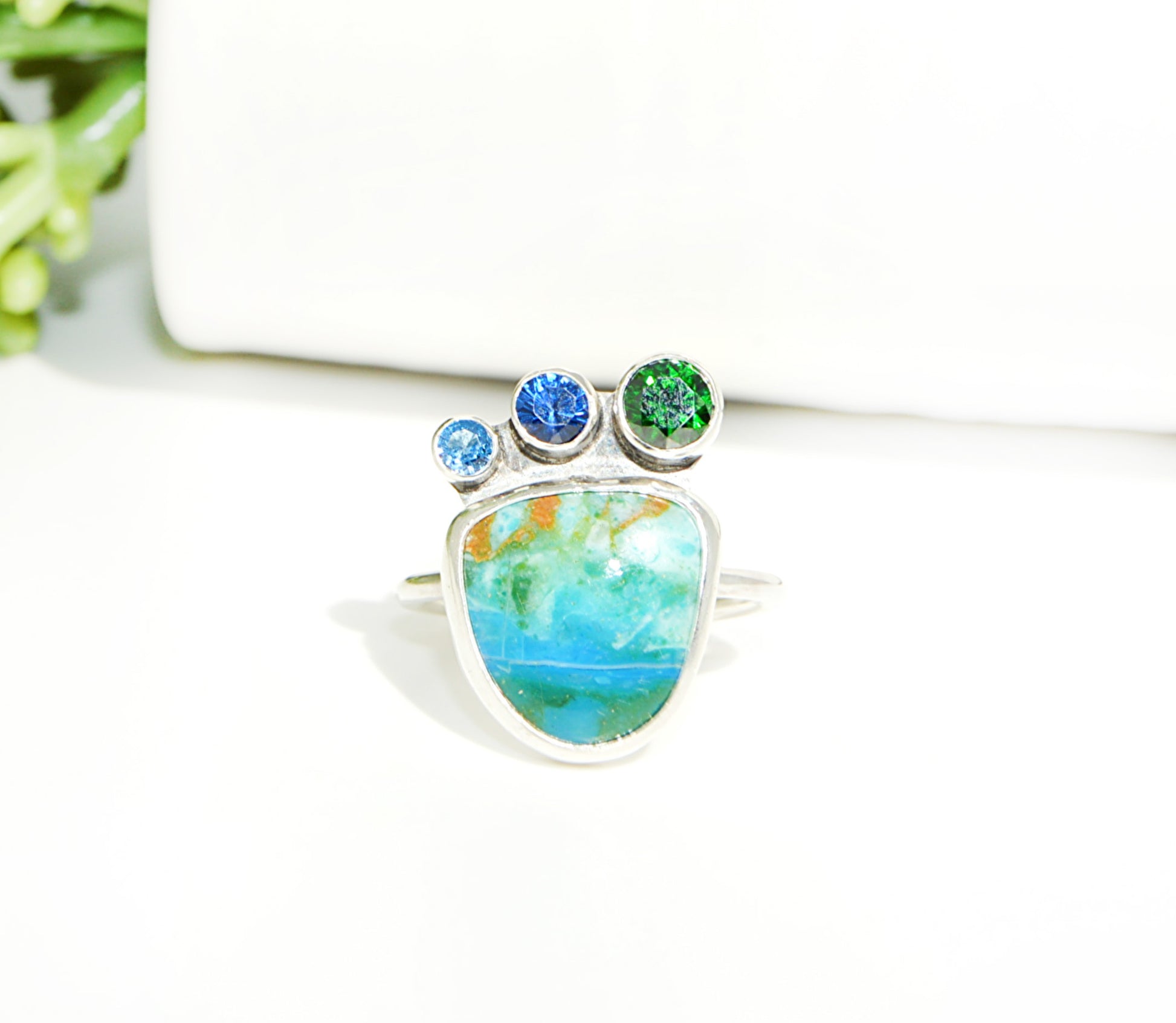 Emerald, and blue topaz join an awesome and rare Peruvian Opal set in fine silver with a sterling silver band. 
