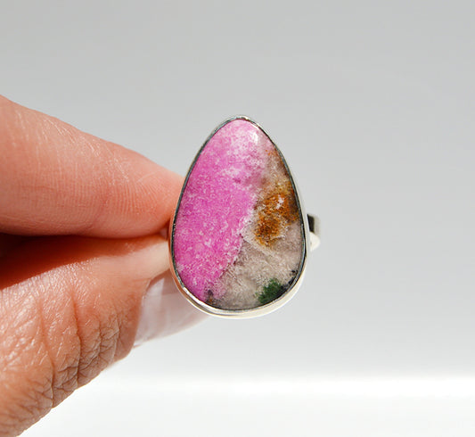 JeniMarie Jewelry with a pink druzy stone with an adjustable band for a comfort fit all set in sterling silver. 