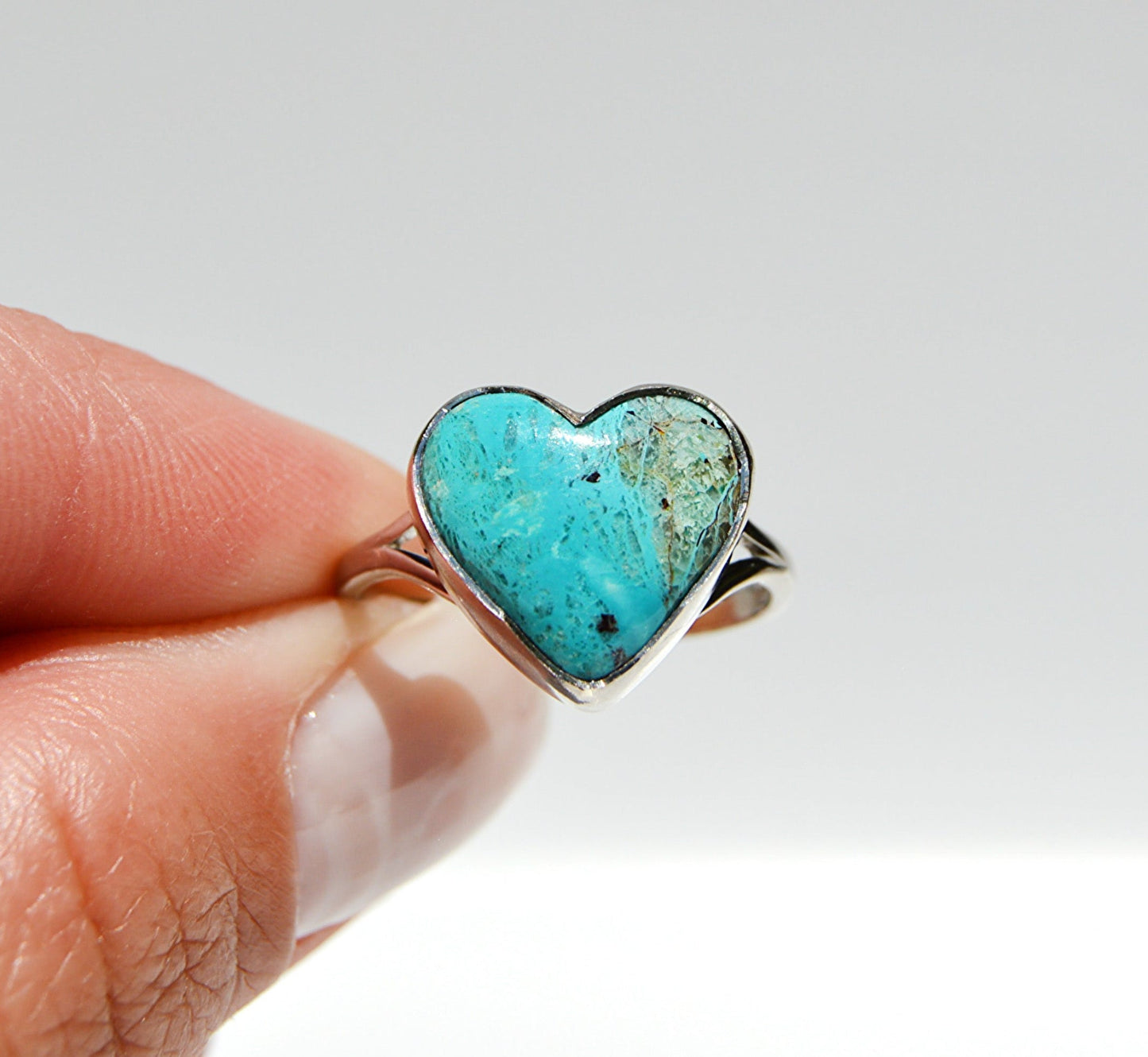 JeniMarie Jewelry with a blue green rare stone shaped in a heart design set in sterling silver. 