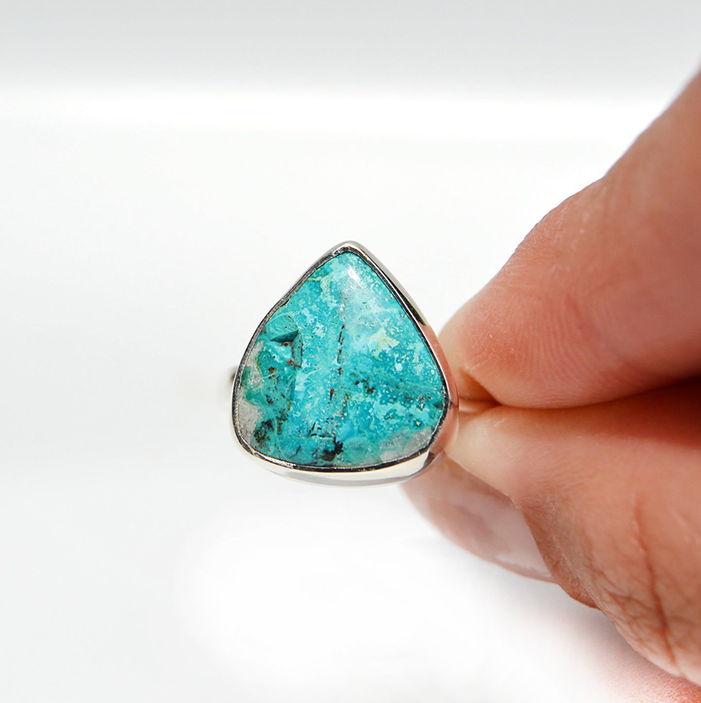 JeniMarie Jewelry with a ocean blue shattuckite stone set in sterling silver giving it a high polish. 