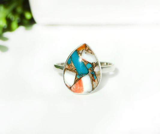 Teardrop-shaped ring featuring blue, orange, and white Spiny Oyster Turquois 