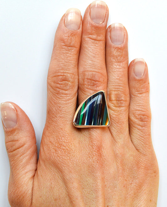 Surfite which is close to Fordite ring set in fine silver using a .925 sterling silver band. 