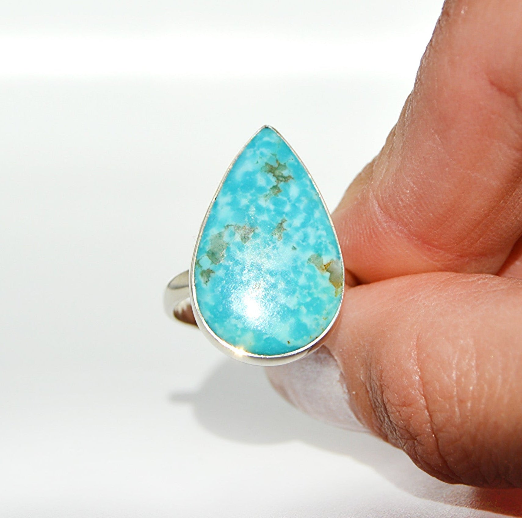 Teardrop-shaped turquoise stone ring made with Sterling Silver