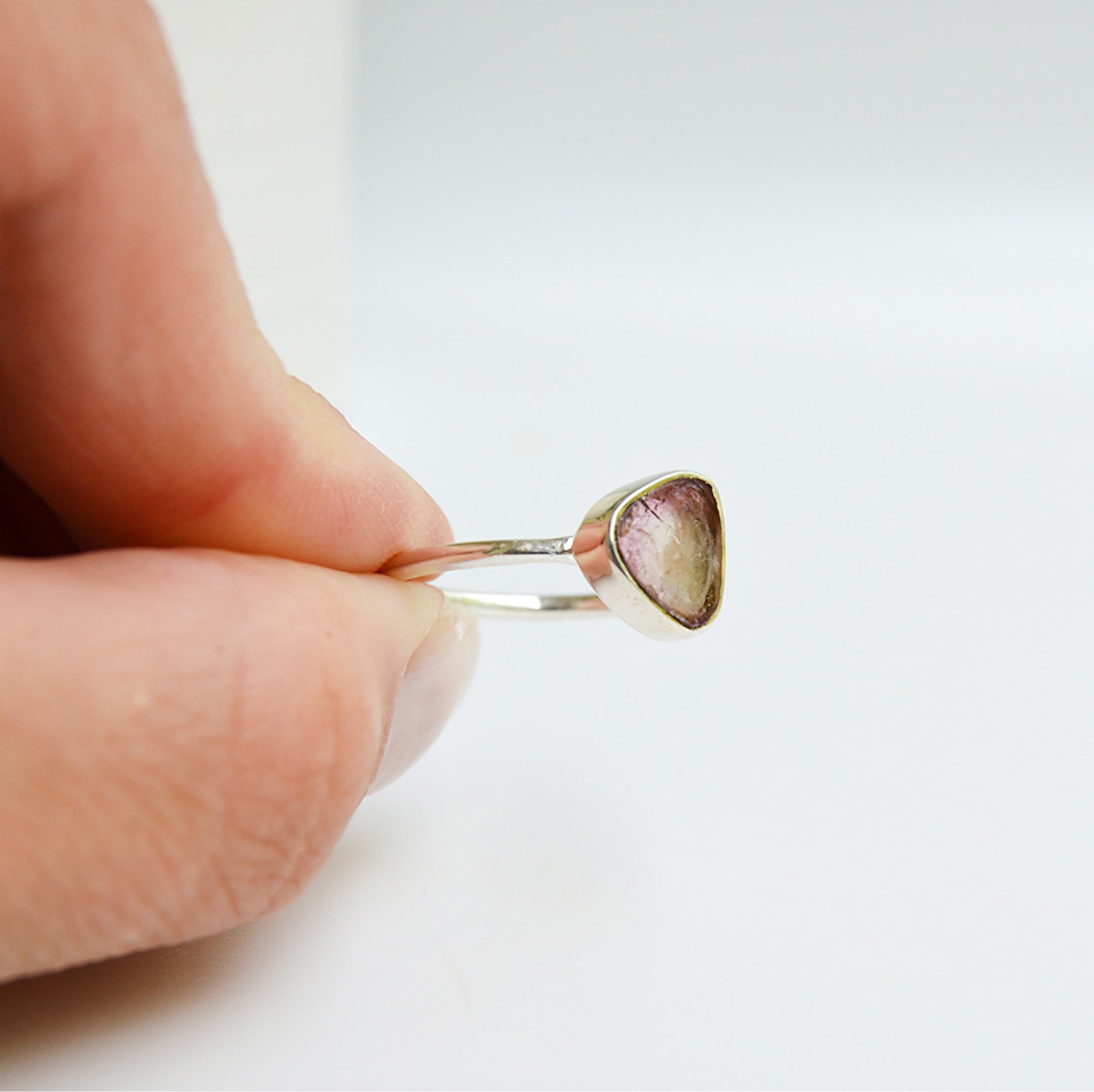 Watermelon tourmaline ring from JeniMarie Jewelry with a tube set stone and a comfort band all using .925 sterling silver. 