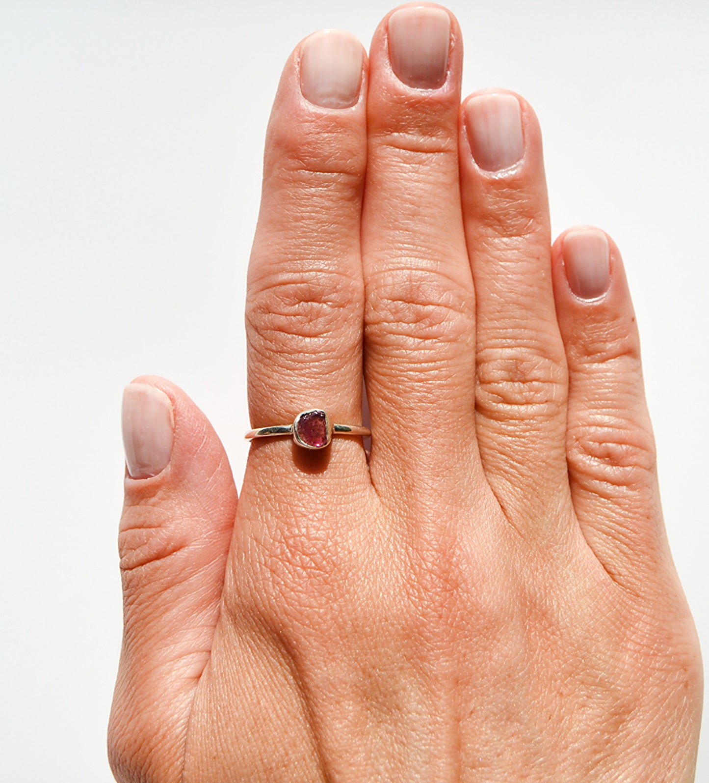 JeniMarie Jewelry with a watermelon tourmaline ring set in sterling silver with a comfort band and polished for a high shine. 